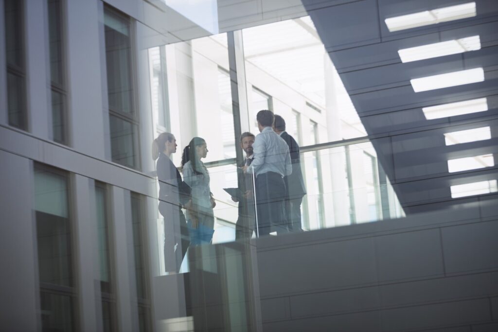 businesspeople-interacting-inside-office-building_107420-74339
