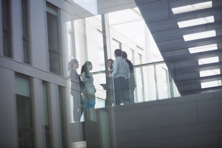 businesspeople-interacting-inside-office-building_107420-74339