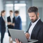 businessman-using-laptop_107420-84795