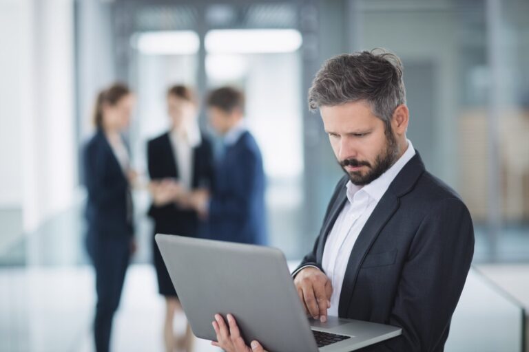 businessman-using-laptop_107420-84795