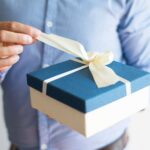 close-up-man-shirt-opening-birthday-gift_1262-17275