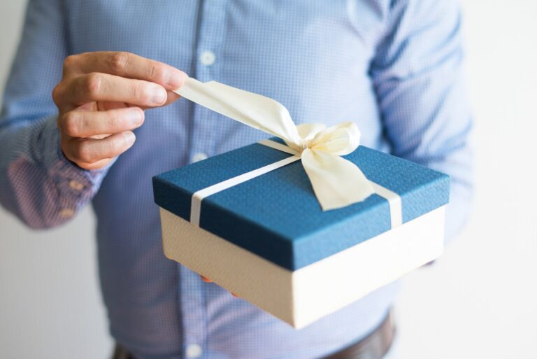 close-up-man-shirt-opening-birthday-gift_1262-17275