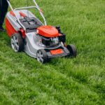 man-cutting-grass-with-lawn-mover-back-yard_1303-22794