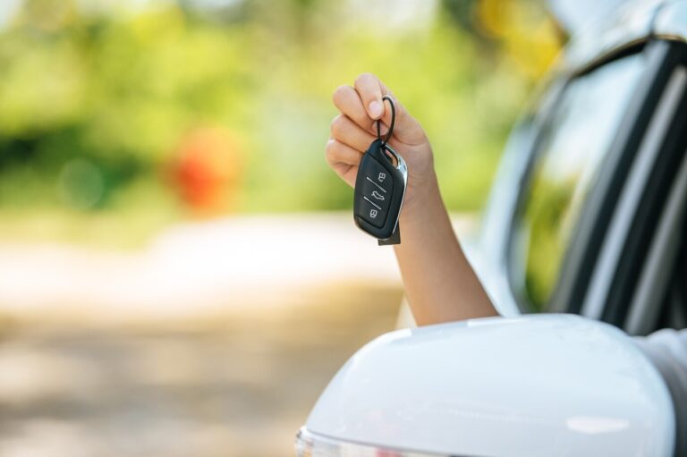 girl-sitting-car-holding-car-keys-hands-out-car_1150-51916