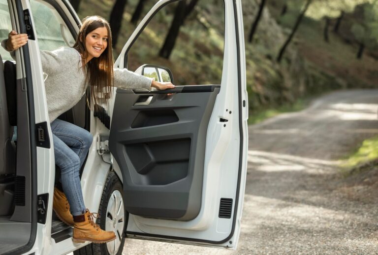 side-view-smiley-woman-getting-out-car-while-road-trip_23-2148851244